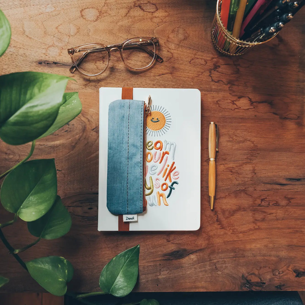 Denim Distressed Blue Notebook Pouch

Keep your go-to notebook and must-have pens together with our Denim Blue Notebook Pouch (honestly, we should’ve made these sooner). Designed with a fabric front, PU back, and a fully nylon-lined interior, it features an elastic band that fits snugly around most notebooks—so you’re ready for everyday ideas on the go.

Vegan Leather Pouch with Zipper
Elastic Fits Books up to 9" High
Zipper closure
9" x 3.75"