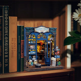 Inspired by the notion that "the meaning of travel is sharing," this charming book nook kit celebrates the power of storytelling, souvenirs, and cultural exchange. Visitors to this cozy bookshop explore a treasure trove of travelogues, handwritten postcards, globes, and keepsakes-each one brimming with whispered adventures from around the world. Let this miniature scene ignite your wanderlust, one tiny story at a time.
