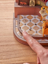 Silent Corner Study is a complete miniature bookshelf insert kit designed for craft enthusiasts and book lovers, featuring pre-cut wooden pieces, vintage-style furniture, bookshelves, and warm LED lighting that creates a cozy reading nook scene. Ideal for retail gift shops, bookstores, and hobby stores, this eye-catching decor item comes in compact, shelf-ready packaging with clear instructions and assembly tools included—making it a thoughtful gift and an engaging DIY project for adults and teens alike.