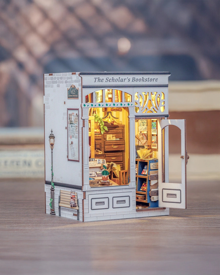 From the intricate woodwork of the storefront to the tiny posters, plants, and meticulously arranged reading materials inside, every piece invites you to slow down, take your time, and craft a scene that feels like a sanctuary for the soul. Whether you place it on your bookshelf or gift it to a fellow book lover, this book nook transforms any space into a story waiting to be told.