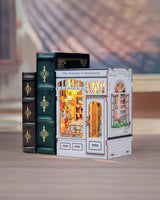 From the intricate woodwork of the storefront to the tiny posters, plants, and meticulously arranged reading materials inside, every piece invites you to slow down, take your time, and craft a scene that feels like a sanctuary for the soul. Whether you place it on your bookshelf or gift it to a fellow book lover, this book nook transforms any space into a story waiting to be told.