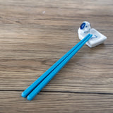 Porcelain dog and bone chopstick rest / pen rest.