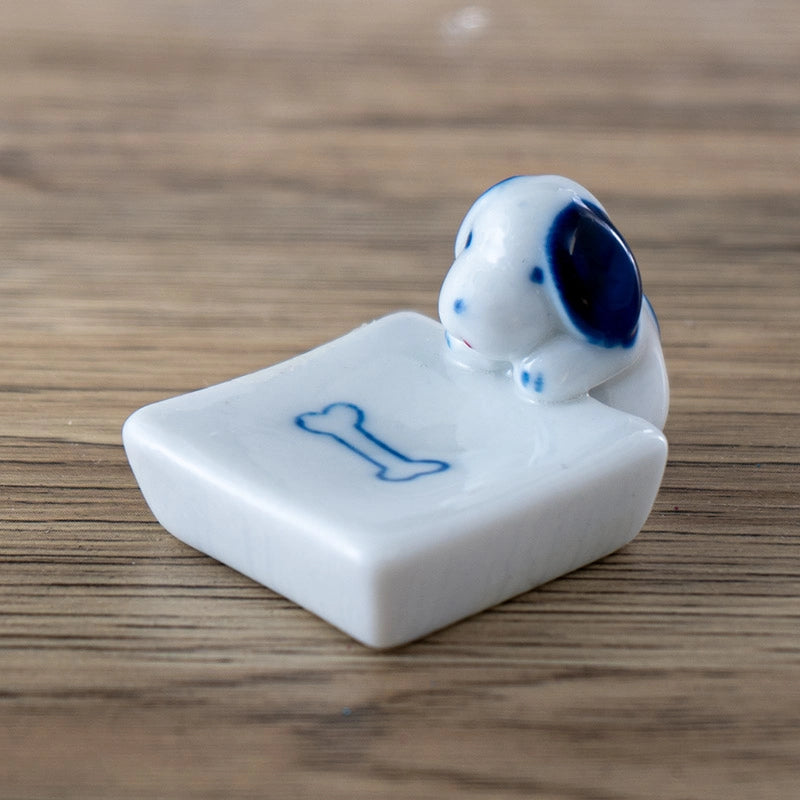 Porcelain dog and bone chopstick rest / pen rest.
