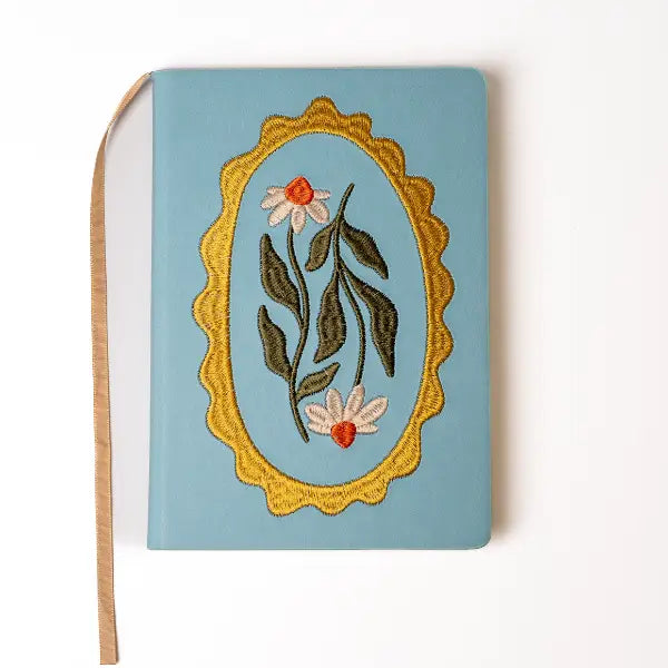 Embroidered Daisy Frame Hardbound Notebook

A premium hardcover notebook featuring precision embroidery on a vegan leather cover. Designed for everyday use, it includes smooth-lined pages, a Smythe-sewn layflat binding for effortless writing, and a satin ribbon to mark your place.

New inside page design
Soft Touch Embroidered Hardcover
5.75" x 8.25"
144 Lined Pages
Contrast Endpages
Satin Ribbon Bookmark &amp; Pen Loop