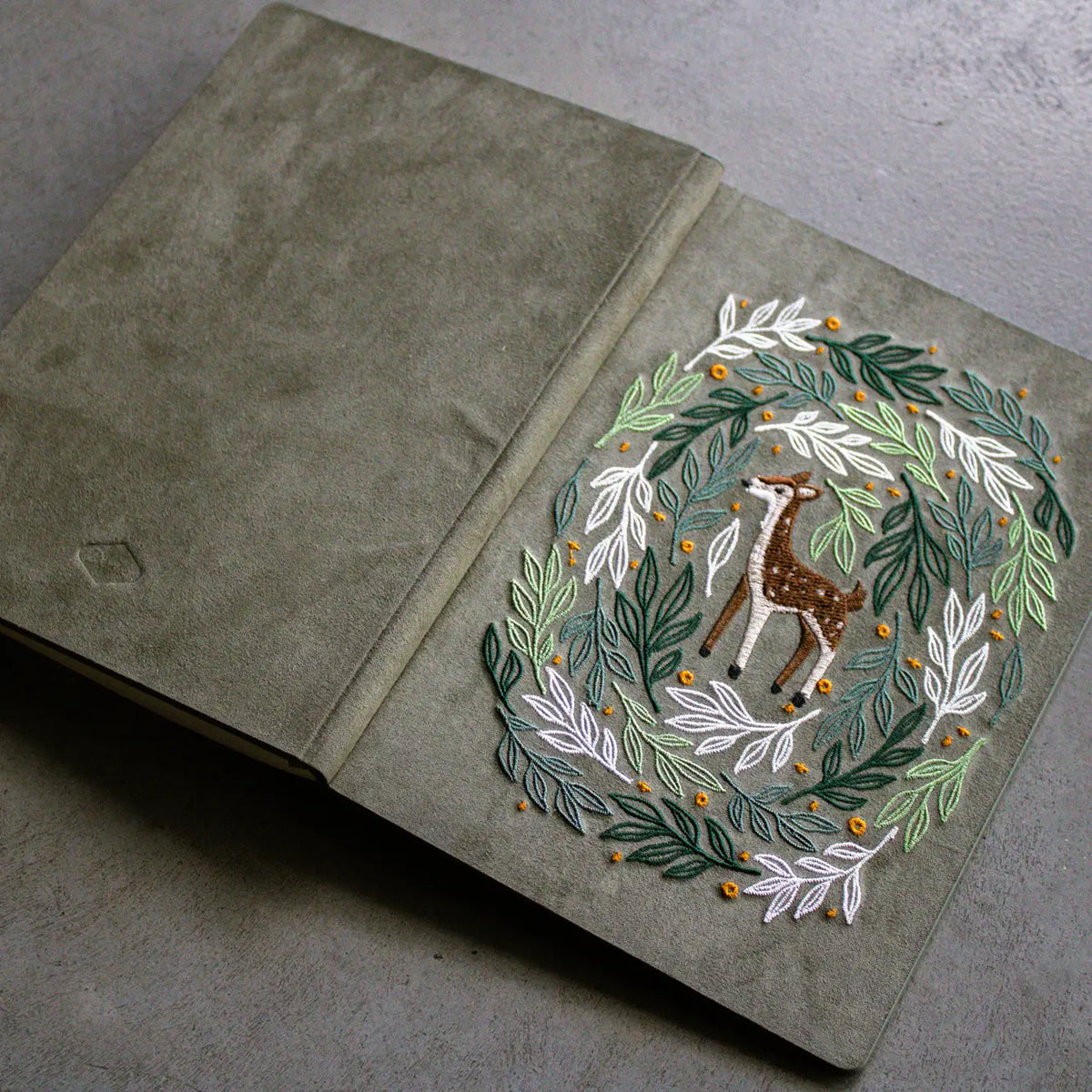 Embroidered Deer Hardbound Layflat Notebook

Premium embroidered cover and beautiful cream-colored lined pages making it easy to keep track of even the smallest details. Complete with a rich, satin ribbon allowing you to bookmark your favorite pages and experiences.

5.75" x 8.25" hardcover journal notebook
Embroidered cover artwork
144 lined pages
Glorious Smythe-sewn binding allows notebook to lay flat
Ribbon Bookmark
Durable binding and high-quality paper for a premium writing experience
Ideal for gifts,
