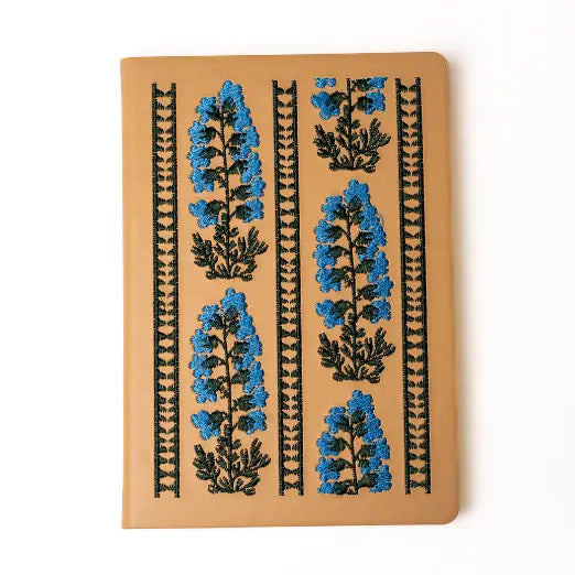 Embroidered Delphinium Flower Hardbound Notebook

A premium hardcover notebook featuring precision embroidery on a vegan leather cover. Designed for everyday use, it includes smooth-lined pages, a Smythe-sewn layflat binding for effortless writing, and a satin ribbon to mark your place.

New inside page design
Soft Touch Hardcover
5.75" x 8.25"
144 Lined Pages
Contrast Endpages
Satin Ribbon Bookmark &amp; Pen Loop