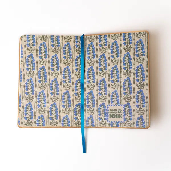 Embroidered Delphinium Flower Hardbound Notebook

A premium hardcover notebook featuring precision embroidery on a vegan leather cover. Designed for everyday use, it includes smooth-lined pages, a Smythe-sewn layflat binding for effortless writing, and a satin ribbon to mark your place.

New inside page design
Soft Touch Hardcover
5.75" x 8.25"
144 Lined Pages
Contrast Endpages
Satin Ribbon Bookmark &amp; Pen Loop