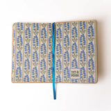 Embroidered Delphinium Flower Hardbound Notebook

A premium hardcover notebook featuring precision embroidery on a vegan leather cover. Designed for everyday use, it includes smooth-lined pages, a Smythe-sewn layflat binding for effortless writing, and a satin ribbon to mark your place.

New inside page design
Soft Touch Hardcover
5.75" x 8.25"
144 Lined Pages
Contrast Endpages
Satin Ribbon Bookmark &amp; Pen Loop