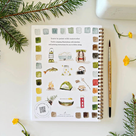 Twelve camping illustrations — a vintage camper, lantern, campfire, tent, canoe, s'mores, and more — each pre-outlined with step-by-step instructions. Paintings take about thirty minutes from start to finish, making it approachable for first-time painters and a favorite for gifting.