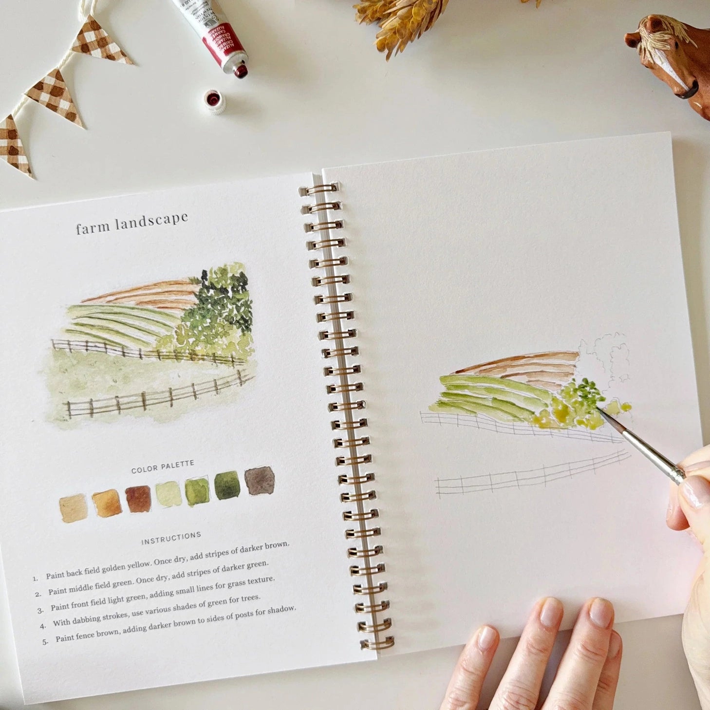 Twelve farm illustrations — a red barn, dairy cow, tractor, horse, windmill, sheep, and more — each pre-outlined with step-by-step instructions. Paintings take about thirty minutes from start to finish, making it a favorite for young painters and the grown-ups who paint alongside them.

Enjoy this peaceful painting hobby on your own, with children, or with friends. Makes a wonderful gift and is perfect for artists of any age.
Details:

12 beginner-friendly illustrations
Thick 120lb watercolor paper&nbsp;
La