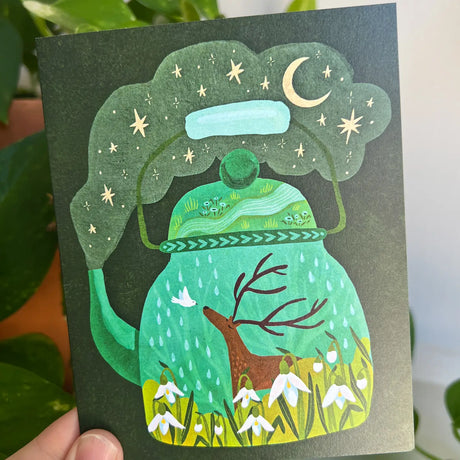 Emmylou Illustrations - Cottagecore Teapot Greeting Card

Blank greeting card featuring a whimsical deer in a teapot surrounded white snowdrop flowers, with the stars and moon above. Perfect card as a get well soon, thinking of you, or thank you card. All greeting cards are hand illustrated by me!&nbsp;

Printed on premium heavyweight matte cardstock, this A2 card is blank inside—ready for your handwritten notes.

Includes a kraft envelope