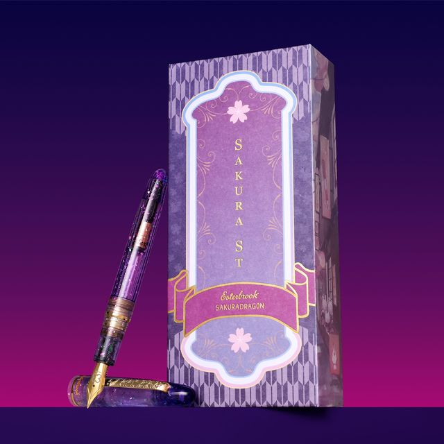 Esterbrook x Sakuradragon Sakura Street Estie Fountain Pen

Created with artist Cindy Duong of Sakuradragon, the Sakura Street Estie brings her imaginative illustrated world to Esterbrook's traditional Estie fountain pen. Its U.S.-blended material combines translucent purple with colorful glitter sparkle, while the custom clip is etched with Cindy's Sakura pattern. Dual Esterbrook and Sakuradragon engraving and a gold-plated converter finish the design. Each pen arrives in special packaging with Japanese gi