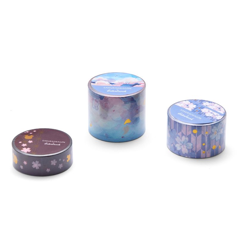 Esterbrook x Sakuradragon Washi Tape - Sky

The Sky Washi Tape turns Cindy Duong's Sakura Street Sky illustration into a continuous scene. Soft clouds and rooftops fill the 3.5 cm-wide tape, with gold foil details appearing throughout the design. Each roll contains five meters for decorating journals, letters, and stationery projects.&nbsp;
