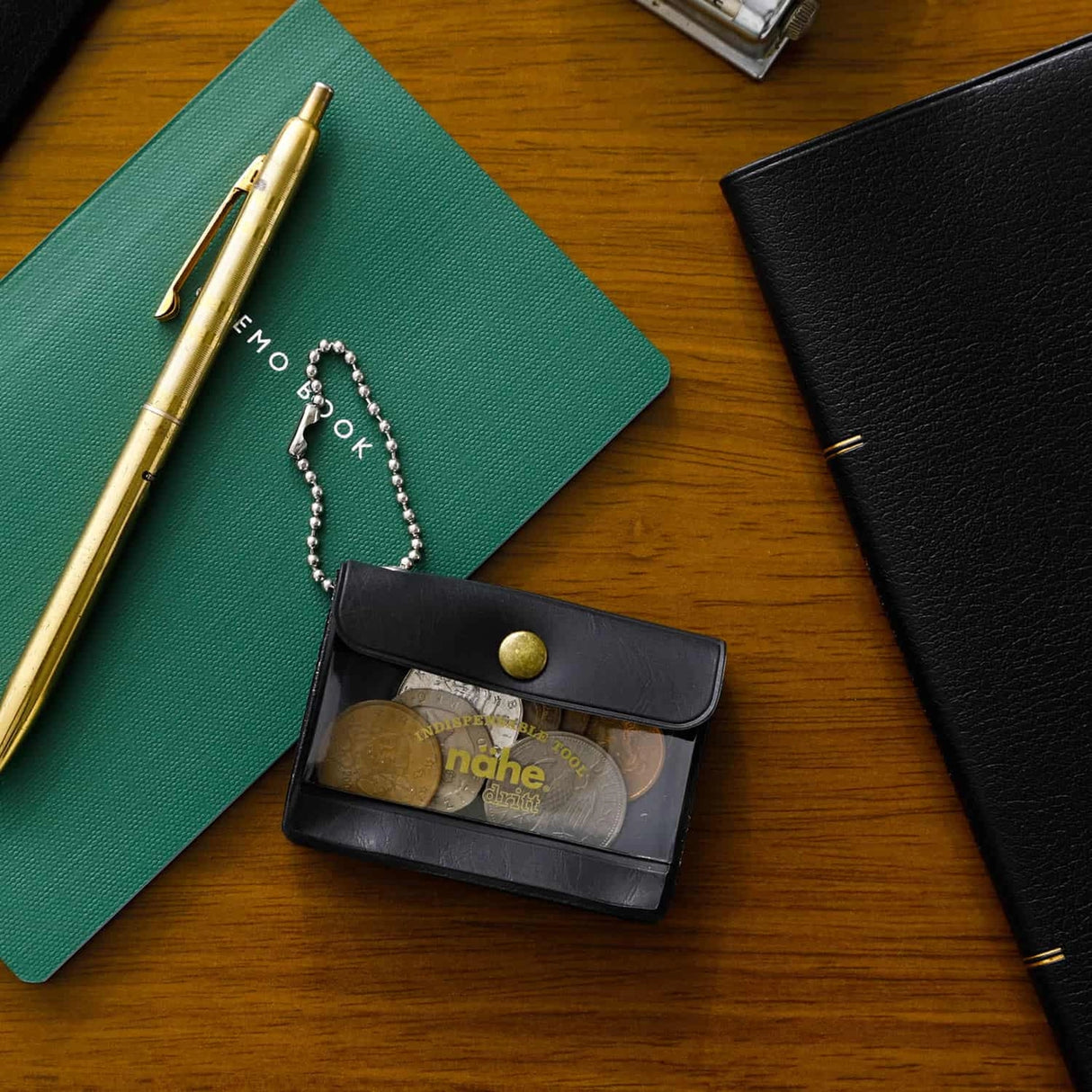 A miniature keychain version of the popular General Purpose Case by nähe. The true-to-original case comes with a clear front pocket with extra inserts inside and out. A ball chain securely attached to the corner of the case lets you hang it onto your keys or bags, perhaps in multiples.

Perfect size to travel with and quickly access your keys, coins, medicine, or small accessories.&nbsp;