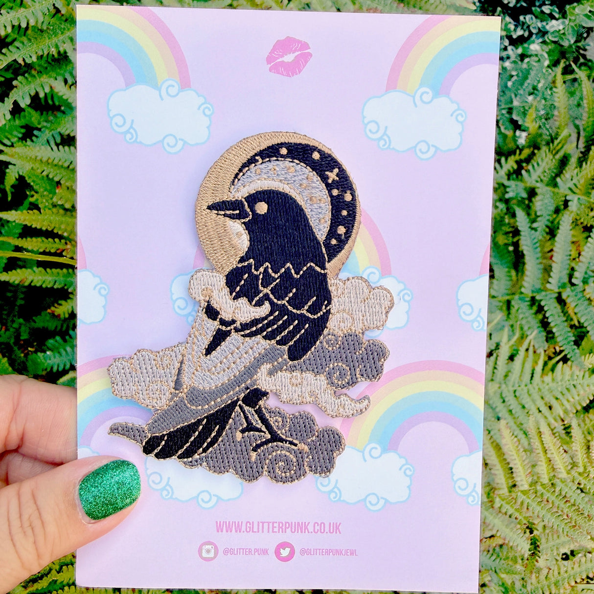 This fabulous patch features a black crow surrounded by grey glittery clouds, and a starry moon with grey backgrounds.

Beautifully woven with black, white, grey & gold threads, this fabulous patch with brighten up any coat, bag or hat!

Measurements: 70mm x 90mm