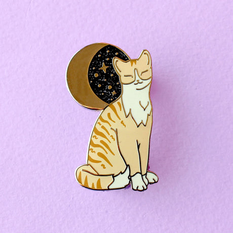 Glitter Punk - Ginger Cat Enamel Pin

Due to popular demand, here is a Ginger Cat enamel pin in a classic Glitter Punk style! Made from gold hard enamel, this 36mm cat has screen printed details, and sits under a glittery moon. It is secured with two pink rubber clasps.