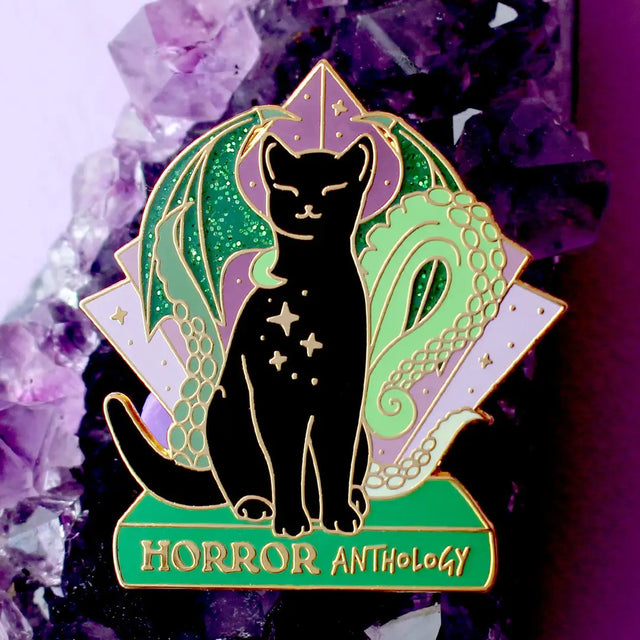 Horror Anthology Enamel Pin; Art Deco Black Cat dark academia literary book cat pin

The 1920s is an iconic time for horror, and this creepy but cute Horror Anthology cat is the perfect way to show off your love for the genre!

It features a black cat perched on a green book with wings and tentacles from indescribable creatures from the deep.