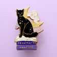 We’ve all sometimes wished we were at home with a hood book, rather than having to deal with the real world! This super cute pin features a black cat sitting on pink &amp; purple books with the slogan ‘I’d rather be reading’. Behind the cat is a large crescent moon and a pair of glittery pastel clouds.

Measurements: 45mm (1.77”)