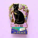 We’ve all had moments where we wish the world would just leave us alone so we can get lost in a good book! This gorgeous enamel pin features a black cat underneath an arch of wisteria, sitting on a pile of books with the slogan ‘Let me Read in Peace’

Measurements: 44mm (1.73”)