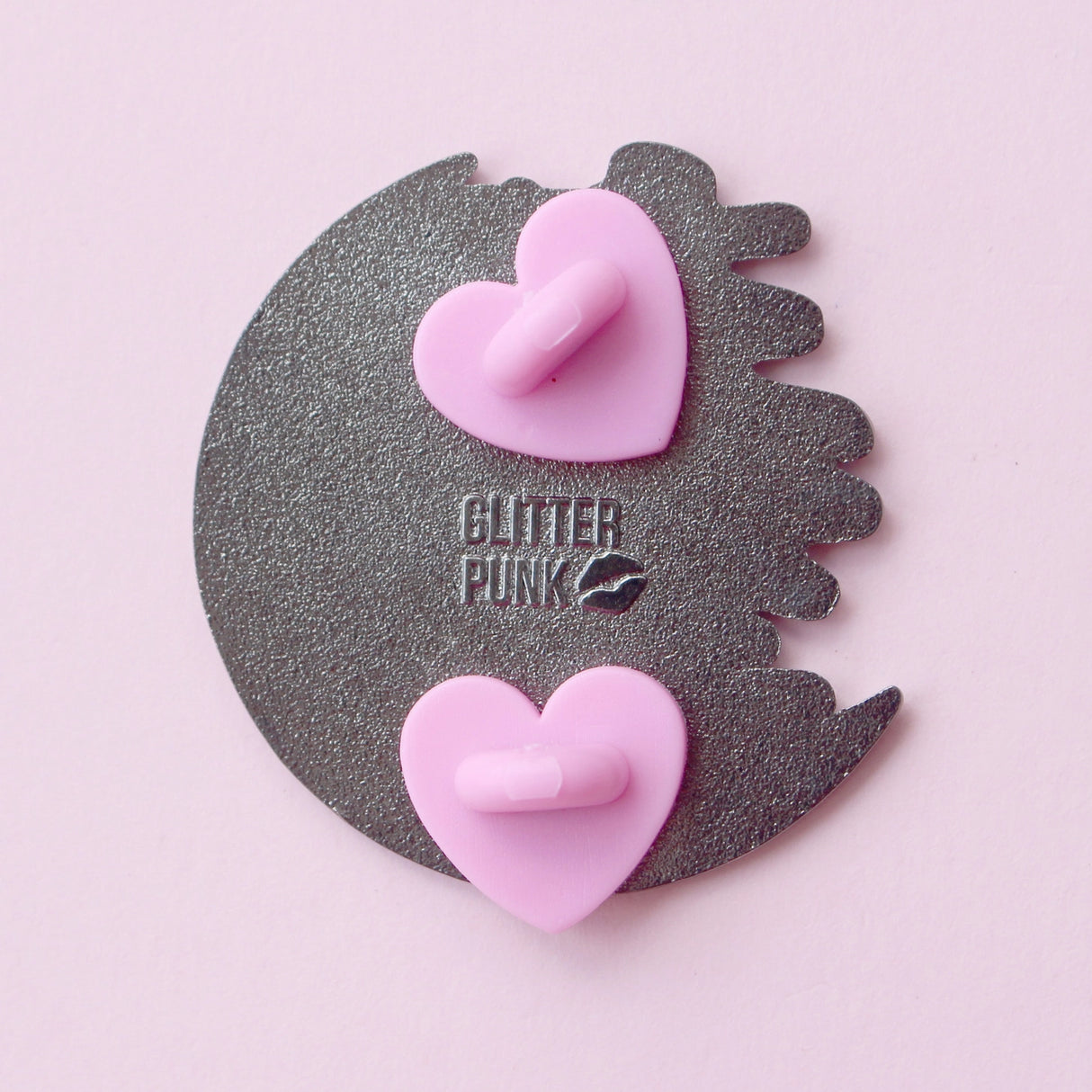 Calling all owners of a long haired pointed / meezer cats! This super cute design features the cat sitting in front of a sparkly moon with a glittery, starry sky in the background.

The pin is 40mm (1.57”) tall, and is made from gunmetal hard enamel, with glitter and UV printed details. It's secured with 2 pink clutches to keep the pin in place.