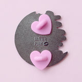 Calling all owners of a long haired pointed / meezer cats! This super cute design features the cat sitting in front of a sparkly moon with a glittery, starry sky in the background.

The pin is 40mm (1.57”) tall, and is made from gunmetal hard enamel, with glitter and UV printed details. It's secured with 2 pink clutches to keep the pin in place.
