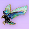 This amazing patch features a raven with its wings outstretched and the northern lights fanning out behind it.

Beautifully woven with black, green, blue & gold threads, this fabulous patch with brighten up any coat, bag or hat!

Measurements: 85 x 87mm