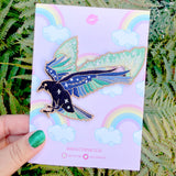 This amazing patch features a raven with its wings outstretched and the northern lights fanning out behind it.

Beautifully woven with black, green, blue & gold threads, this fabulous patch with brighten up any coat, bag or hat!

Measurements: 85 x 87mm