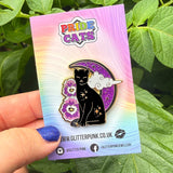 Celebrate your Pride with this fabulous Pansies Cat pin!

It features a black cat in front of a sparkly purple moon, next to some pansies in the black, grey, white & purple colours of the Ace Pride flag.

Each pin has a pair of heart shaped rubber pin backs, and is presented on a Pride themed Glitter Punk backing card. This pin is part of my Pride Cats collection, a 10-part set of enamel pins celebrating pride!

Measurements: 39mm (1.53”)