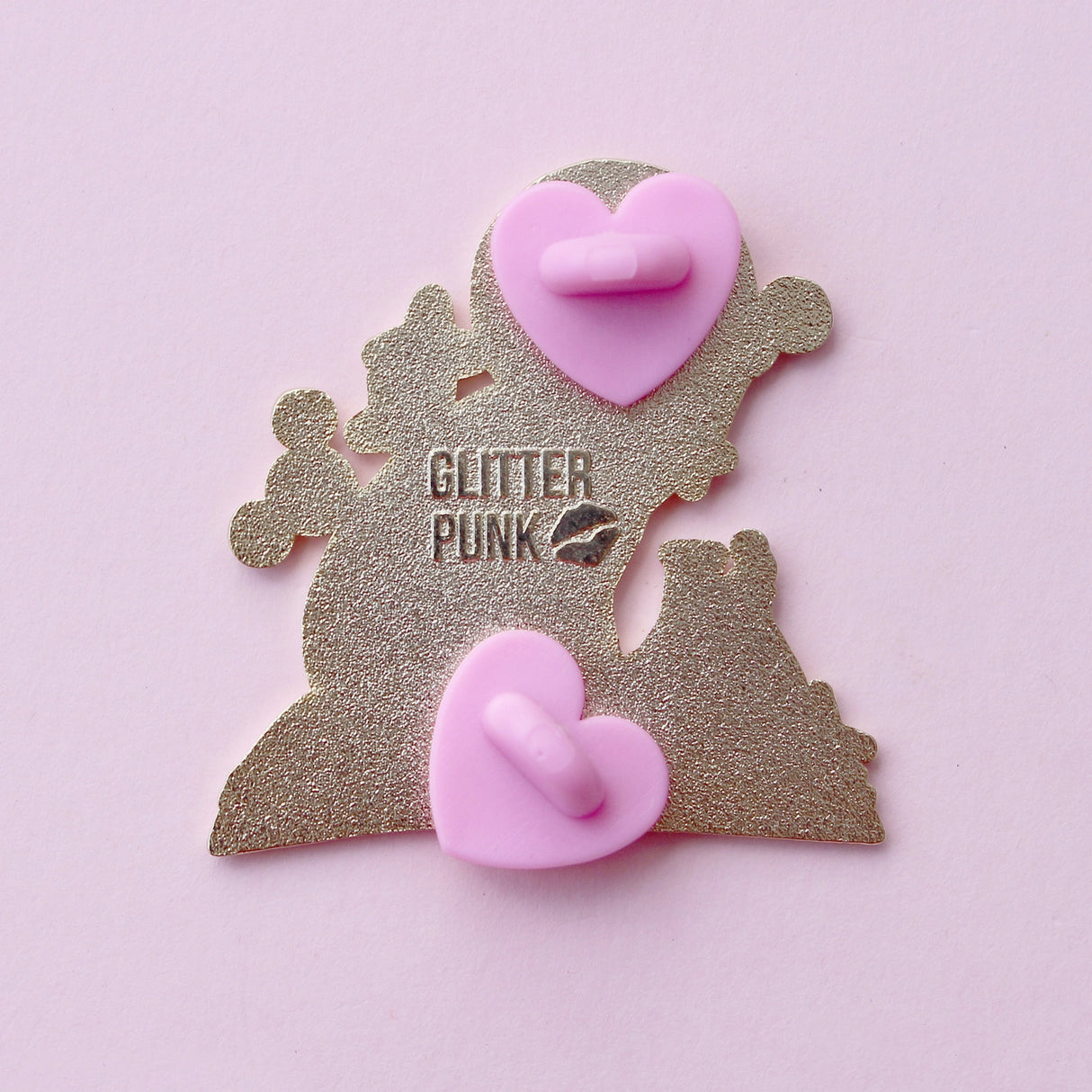 If you’re passionate about science and partial to cats, this awesome pin is perfect for you! It features a black cat sitting on a book and playing with atom parts. It also features a glittery moon and two beakers filled with purple liquid.

The pin is 42mm (1.65”) tall, and is made from gunmetal hard enamel, with glitter and UV printed details. It's secured with 2 pink clutches to keep the pin in place.