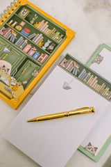 For cat lovers, book lovers, and anyone who believes planning should be delightful, the Cat Library Undated Weekly Planner brings a playful twist to everyday organization. The cover features a vintage-inspired library scene where curious cats lounge, climb, and quietly cause chaos among the shelves. Finished with gold foil details and gold wire binding, this planner feels whimsical yet polished.