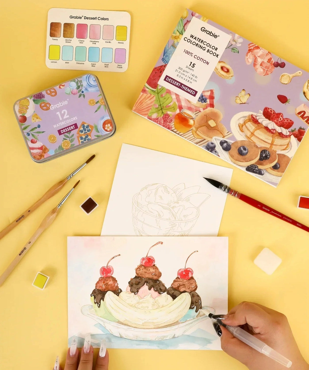 INDULGE YOUR CREATIVITY
Treat yourself to the sweetest watercolor adventure and build a colorful haven for your imagination. This delightful bundle comes with our custom 12-color Dessert palette and a whimsical coloring book featuring 15 pages of mouth-watering treats—from stacked pancakes and boba tea to elegant tiered cakes and delicate macarons. Bring these cozy, bakery-inspired scenes to life and watch your skills flourish!

A SWEET SETTING FOR CREATIVE ARTISTS
Embark on a delicious creative journey wit