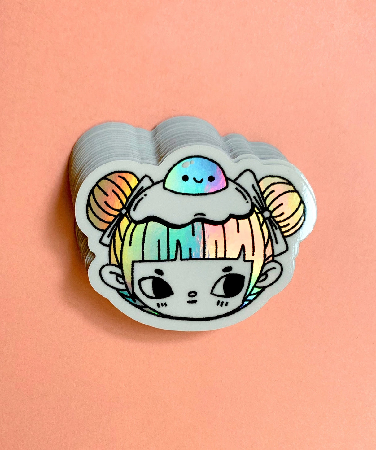 "Egg Buns" Vinyl Sticker made from Hannakin illustration with holographic accents (hair and egg yolk) and shiny gloss finish.

Made from a durable waterproof vinyl with a matte laminate that protects it from scratching, rain and sunlight.