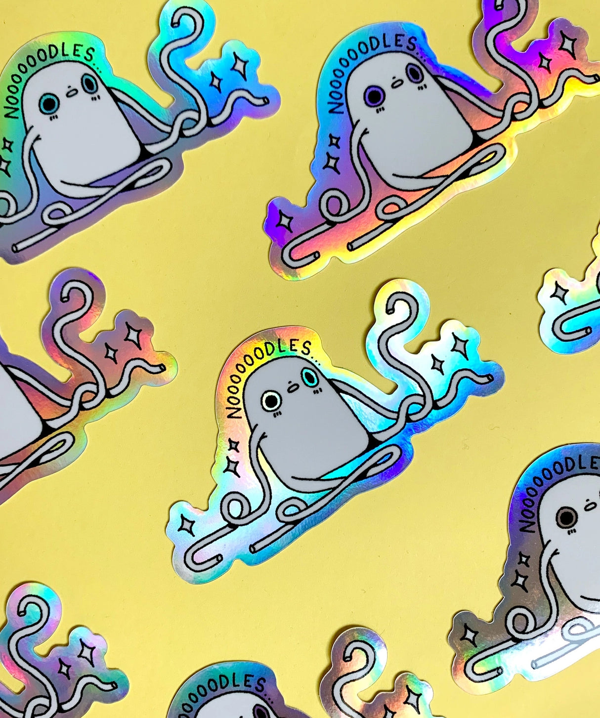 "Noodles" Vinyl Sticker made from Hannakin illustration with holographic accents (background) and shiny gloss finish.

Made from a durable waterproof vinyl with a matte laminate that protects it from scratching, rain and sunlight.