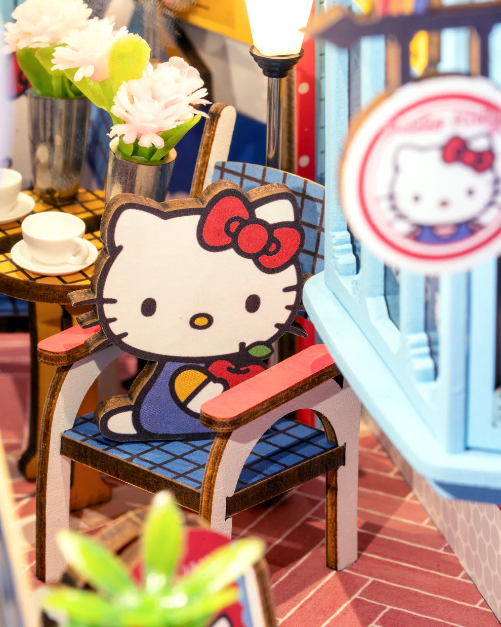 Step into the delightful world of Hello Kitty Town Square with this charming DIY miniature book nook! This beautifully crafted scene features a cozy alleyway filled with inviting cafes, lush plants, and charming little shops, capturing the peaceful vibe of a lively town square. At the heart of the alley, Hello Kitty stands happily, adding a sense of joy and warmth to the entire scene.