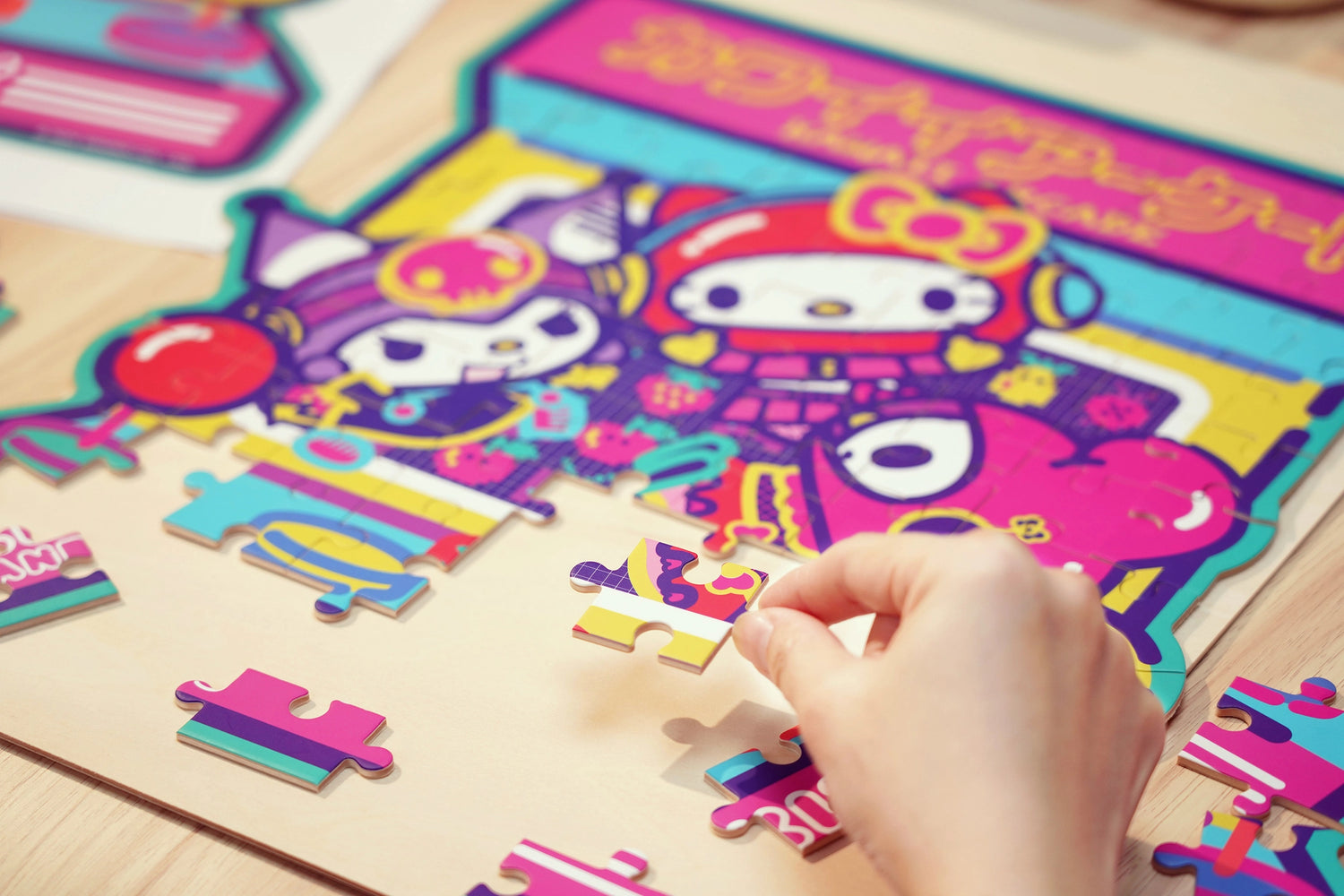 Discover joy with the Hello Kitty Wooden Jigsaw Puzzle: Kawaii Arcade (99pcs). This officially licensed Sanrio product features iconic Hello Kitty in 96 vibrant wooden pieces. Crafted for durability and a seamless fit, it's a delightful challenge for fans of all ages 8+. Embrace positivity and bring Hello Kitty to life with this charming puzzle – perfect for relaxation and family fun. Display your completed masterpiece proudly and celebrate the timeless appeal of Hello Kitty.