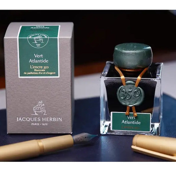 Ink 350, from the exclusive Jacques Herbin Prestige Collection, celebrates the launch date of the Jacques Herbin house in Paris in 1670. Vert Atlantide ink, a dark, intense colour, is illuminated with silver and gold flakes.

This ink is a tribute to the navigator Jacques Herbin, whose legend tells of his interest in lost places such as Antlantide.&nbsp;

Hand bottled with wax-dipped cap and seal.
50ml bottle.
Made in Paris.