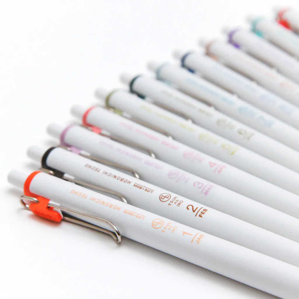 The Hobonichi Techo uses 12 soft colors across the book. The TSUKI no IRO stationery series incorporates these colors into simple designs.

This set of six Uniball One pens features vibrant, bold ink colors selected in colors that go well with the printing colors used for each of the twelve months in the Hobonichi Techo.
The twelve colors are divided into two sets of six pens—one for January through June, and the other for July through December—each housed in an original case.