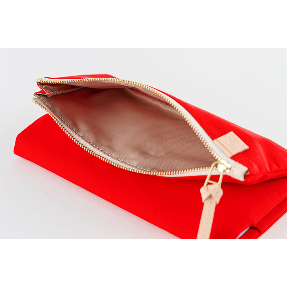 The inside of the pocket is lined with black fabric, creating a striking contrast with the mustard exterior.
