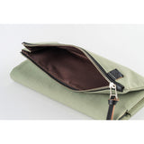 The inside of the pocket is lined with black fabric, creating a striking contrast with the mustard exterior.