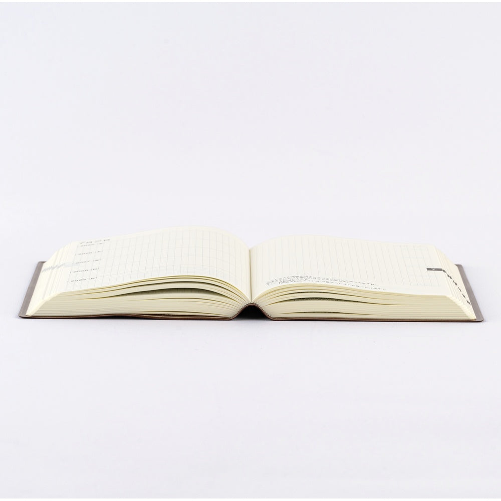 The book has the same thread-stitch binding as a dictionary, allowing it to lay flat open for comfortable writing. It stays flat even if you don’t hold it down.