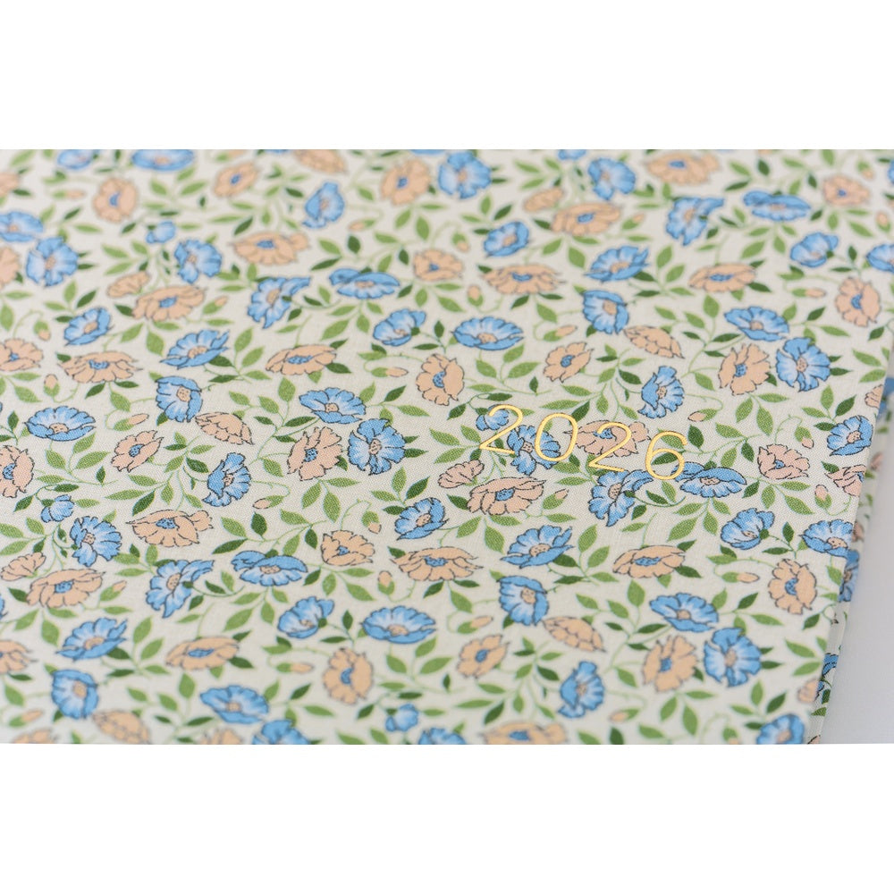 Hobonichi Liberty Fabrics: Sasha Kiora ENG / A5 / Jan Start HON Floral patterned fabric with blue, orange, and green flowers on a white background