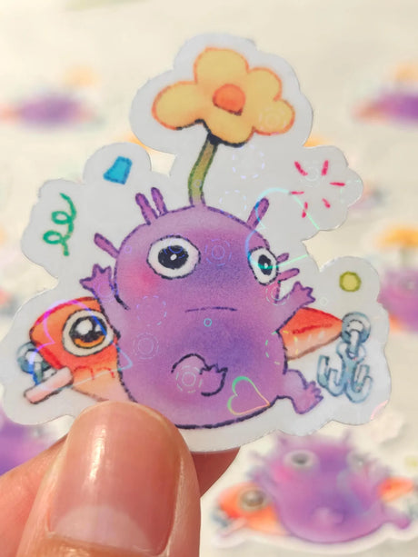 This is a glossy vinyl die-cut paper sticker with holographic features, illustrated and made in-house by me. It's waterproof and ideal for decorating hard surfaces like laptops, water bottles, and phone cases, adding a cute touch to your belongings.&nbsp;

Material: premium glossy waterproof vinyl