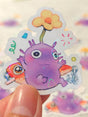This is a glossy vinyl die-cut paper sticker with holographic features, illustrated and made in-house by me. It's waterproof and ideal for decorating hard surfaces like laptops, water bottles, and phone cases, adding a cute touch to your belongings.&nbsp;

Material: premium glossy waterproof vinyl