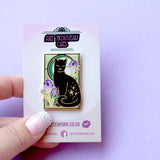 This cute Iris Cat enamel pin features a sweet black cat surrounded by iris (flag) flowers, in front of a glittery moon set against an ornamental green art nouveau background.

The pin is secured by two purple heart backs and comes on a special ‘Art Nouveau’ Glitter Punk backing card, making it perfect for a gift or to keep as a special treat for yourself.

This pin is part of my Art Nouveau Cats collection – 8 enamel pins based on the fabulous 19th/20th century art movement. Check out the full collection a
