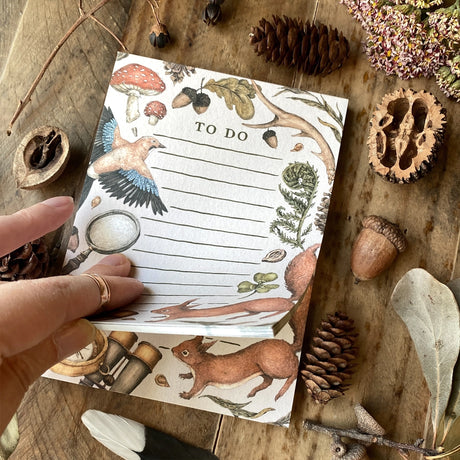 Whimsical, nature-inspired notepads perfect for writing your to do list, grocery list, and more. 50 pages, with full color illustration on the front of every page. Matte finish perfect for writing. Packaged in a clear cello sleeve.

Dimensions: 5.5"x4"
