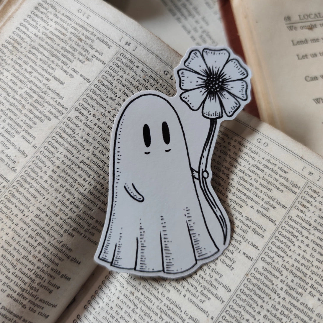 Die-cut vinyl sticker featuring an adorable ghostie pal with a flower for you! Design from an original Jon Turner ink drawing.