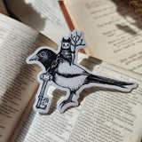 Die-cut vinyl sticker featuring a little spirit riding his noble magpie steed, the keepers of a mysterious key. Design taking from an original ink drawing by Jon Turner.