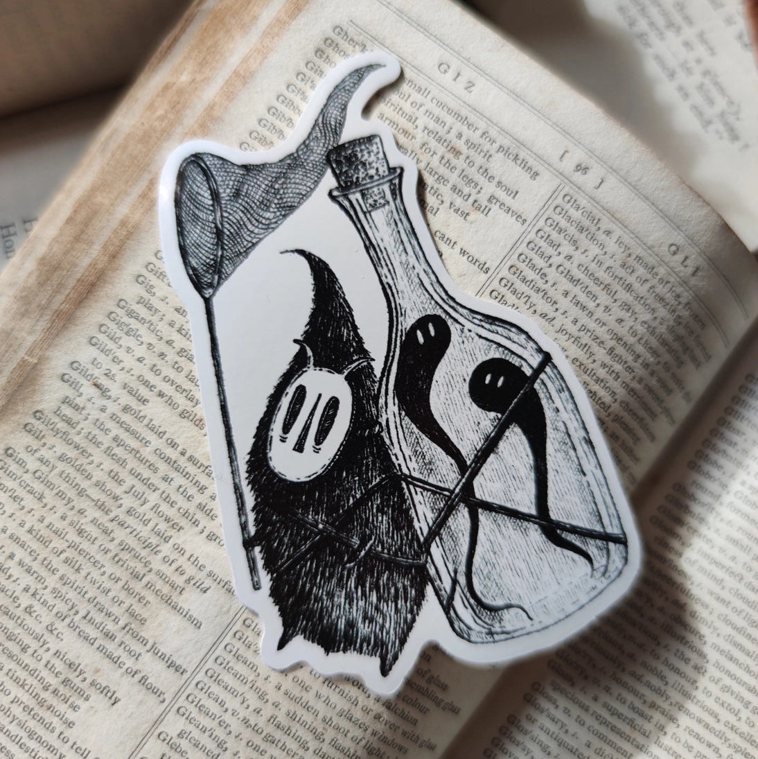 Die-cut vinyl sticker featuring a little bottle-backed ghost hunter, taken from Jon Turner's book Fragments.