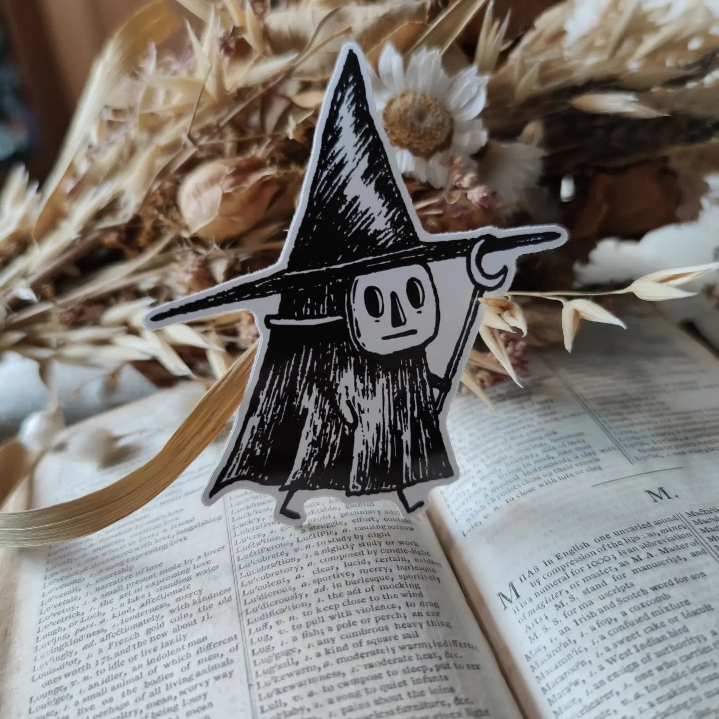 Sticker featuring a tiny witch spirit, from my original pen and ink artwork.

Die-cut vinyl sticker, suitable for interior or exterior use. Available as a single sticker or a set of five matching stickers to share with friends. Measures approximately 8.5cm (3.3 inches) at its tallest point.