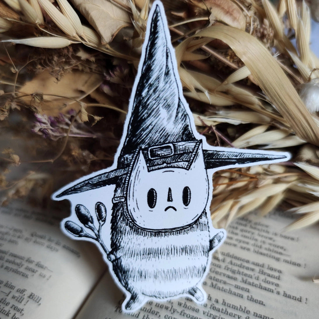 Sticker featuring a tiny wizard spirit in a big hat, from my original pen and ink artwork.

Die-cut vinyl sticker, suitable for interior or exterior use. Available as a single sticker or a set of five matching stickers to share with friends. Measures approximately 8.5cm (3.3 inches) at its tallest point.&nbsp;